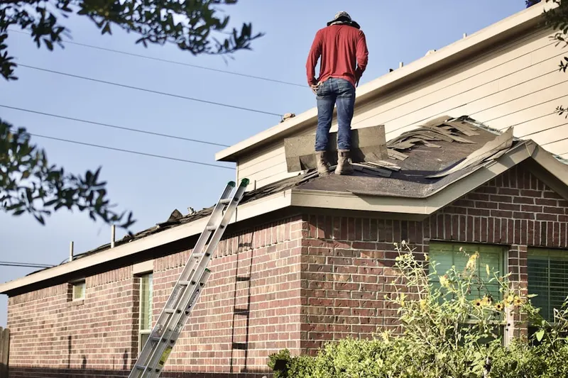 Professional roofer working on a residential roof in North Beach-Blue Ridge